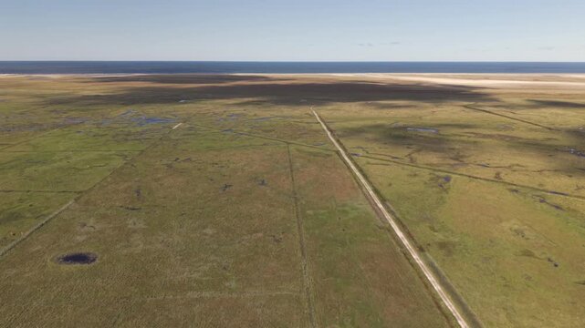 The beautiful Dansk island Romo from top as a fly over across the flat country and the moor and green grassland