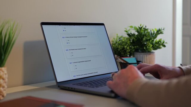 Middle Aged Man Working Remotely From Home Conducting Cybersecurity Audit for Consulting Firm - Information Security Concept