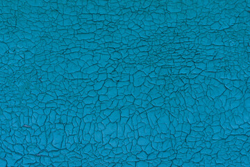 Old vintage cracked wall, retro blue background. Peeling paint aquamarine backdrop. Worn Texture, cracked surface.