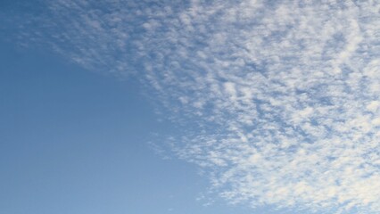 Clear blue sky with cirrus clouds  a natural texture for design, meteorological materials, educational content, and seasonal projects