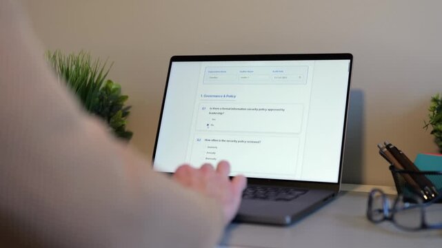 Middle Aged Man Working Remotely From Home Conducting Cybersecurity Audit for Consulting Firm - Information Security Concept