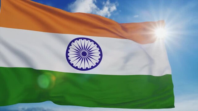 The Indian flag with saffron white green stripes and the Ashoka Chakra waves in the sun national symbol