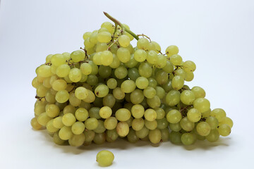 A Big, Heavy Cluster Of Ripe Green Or White Grapes Isolated On A Clean White Surface.