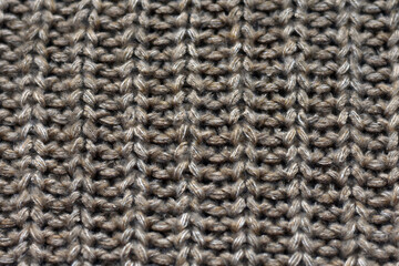 Texture of beige knitted fabric as background.  Banner for design. Knitted material, scarf, warm clothes. Winter, sale concept.