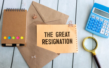 Torn notebook paper on gray copy space background with text THE GREAT RESIGNATION