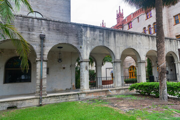 Spanish-style architecture with columned arches and palm landscaping in st Augustine, Florida.