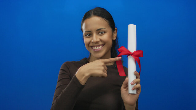 Woman holding diploma against blue background with red ribbon symbolizing graduation success and education achievement.