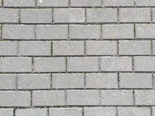 Obraz premium Fondo de textura de pavimento de adoquines rectangulares de hormigón gris con patrón de ladrillo