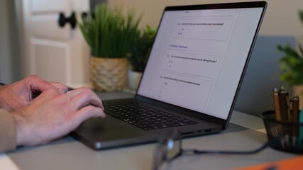 Middle Aged Man Working Remotely From Home Conducting Cybersecurity Audit for Consulting Firm - Information Security Concept