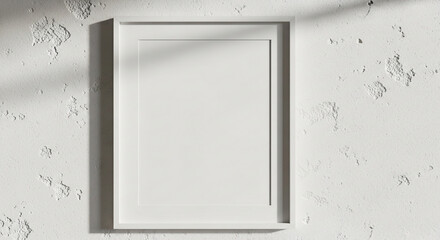 White frame on a textured white wall with sunlight casting a shadow from above