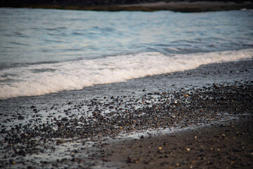 Gentle Wave Washing Over Pebble Beach Shoreline