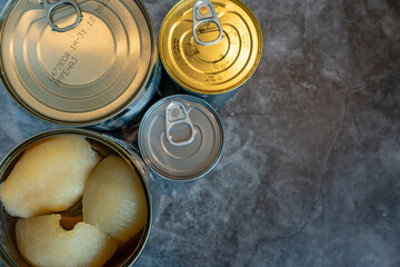Arrangement of open and closed cans of fruit with copy space. 