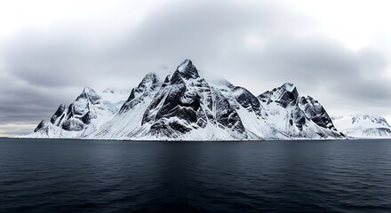 Snowcapped mountains rise majestically from the dark, choppy sea under a dramatic, cloudy sky