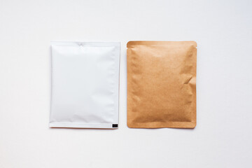 Blank craft plastic pouch, white pack on studio background with shadow, mylar bag isolated for coffee or food, cosmetic products, snack, candy. Different sizes, mock up.