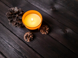 A minimalist flat lay featuring a brown glass candle