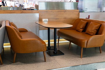 Modern cafe seating with leather sofas and wooden table