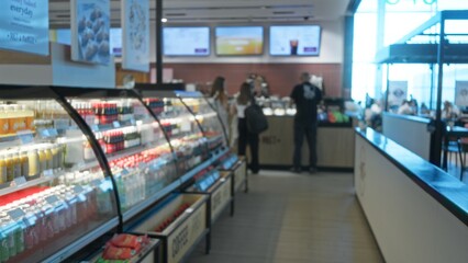 Blurred grocery aisle with defocused refrigerated display and shelving in shallow bokeh shop;...