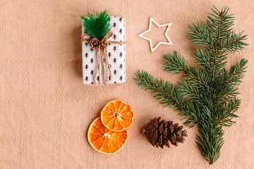 Collection of Christmas objects - gift box, frame, eve fir, dried orange, pine cone, star. New Year and winter minimal holiday frame composition. Flat lay, top view, place for text.