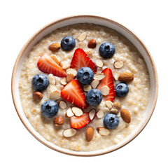 Overhead view of healthy oatmeal bowl topped with fresh strawberries blueberries and sliced almonds in bright natural light on a black background with a subtle texture