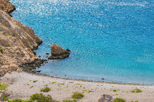 Crystal clear waters and rocky beach cove on a sunny day