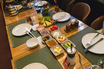 Baku, Azerbaijan. Traditional Azerbaijani breakfast served with traditional bakery qogal, black tea, fresh vegetables.