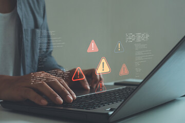 Cybersecurity concept showing a programmer typing on laptop with warning alert icons and code errors, symbolizing data breach, system vulnerability and cyber threat detection in digital networks.