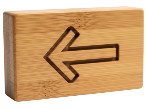 Wooden block with carved left arrow symbol for direction or navigation