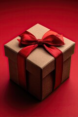 Obraz premium Brown gift box with red ribbons on a red background.