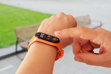 Smart band showing detailed activity statistics outdoors, highlighting daily progress, health monitoring, and modern wearable technology