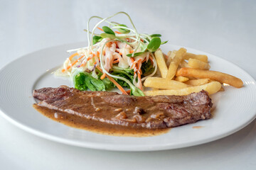 Close up of Grilled beef steak, boiled french fries and vegetable salad;Selective focus
