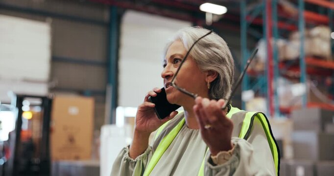 Angry, woman and phone call in warehouse for logistics issues, delivery complaint and order error. Mature person, mobile or conflict for lost package, stock shortage and damaged goods of distribution