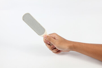 hand holding foot file tool isolated on white background