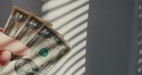 Hands display vintage currency in gentle light, Closeup of fingers grasping old notes under sunlight - Powered by Adobe