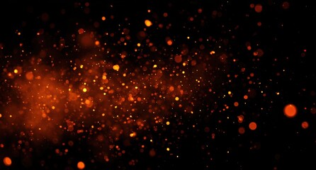 Festive orange and yellow light bokeh effects like fireworks or sparks on black background, celebration and party atmosphere
