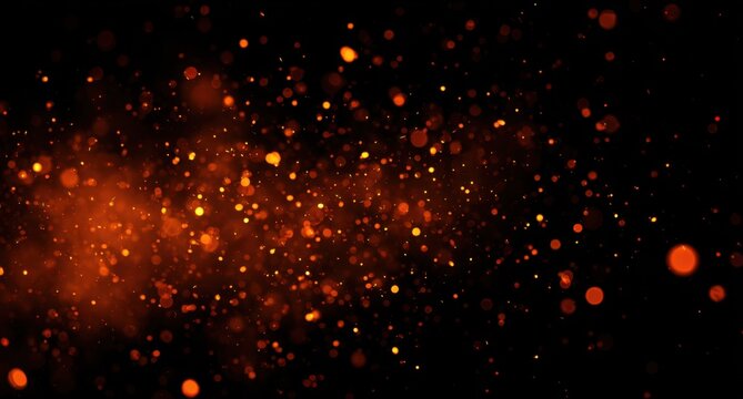 Festive orange and yellow light bokeh effects like fireworks or sparks on black background, celebration and party atmosphere