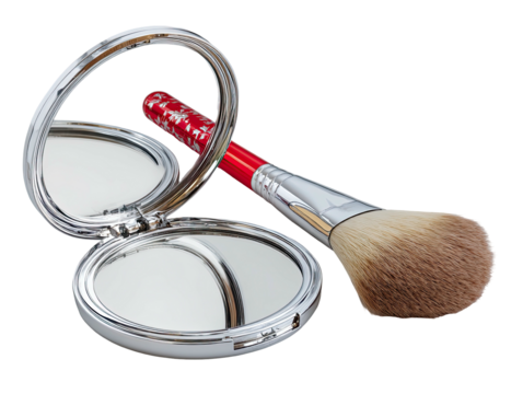 Open compact mirror with red makeup brush on dark backdrop