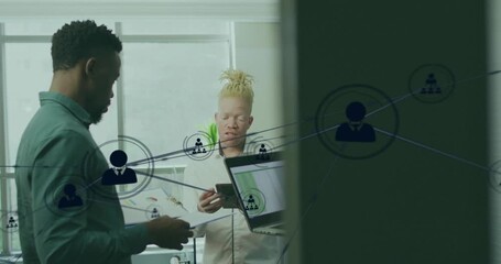 Network overlay forming on glass linking team to nodes as comparing laptop tablet docs for business - Powered by Adobe