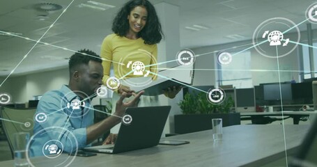 Pair reviewing docs while typing, generating spreading network nodes over laptop for business data - Powered by Adobe
