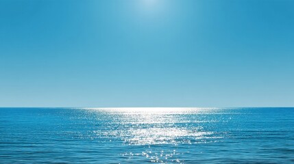 Obraz premium Bright Blue Ocean Surface Reflecting Sunlight Under Clear Skies, Capturing Tranquil Beauty of Seascape During Daytime, Ideal for Relaxation Themes