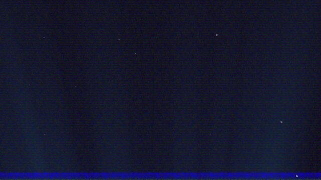 Signal glitch causing grainy navy field shifting scan lines and specks fading, showing artifacts