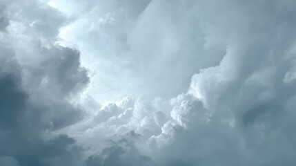 Obraz premium Dramatic Storm Clouds Above with Various Shades of Gray and White, Capturing an Intense Sky Filled with Atmospheric Energy and Motion