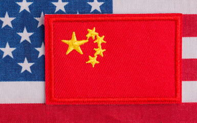 Chinese flags against the background of the US flag