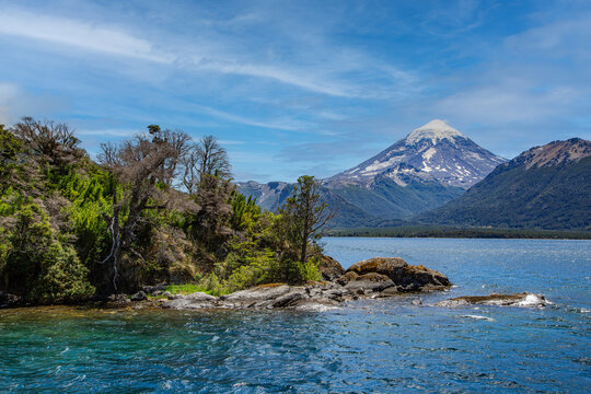 Snow-capped Lanin volcano over patagonian lake on a clear summer day. Lanin National Park, Patagonia, Argentina
