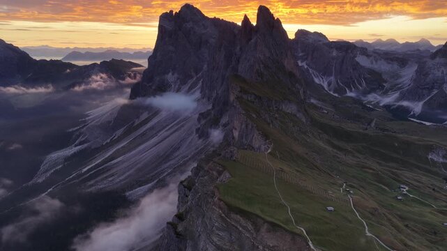 Cinematic aerial video of spectacular sunrise at the Seceda mountain ridge line in the Italian Dolomites