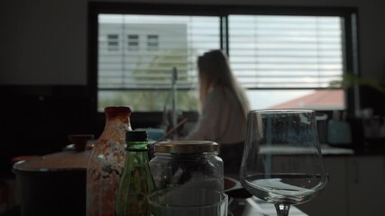 Cleaning dirty dishes in the kitchen while enjoying the morning light
