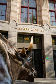 Amsterdam, Netherlands - August 10, 2025: Amsterdam Stock Exchange (AEX) Entrance with Bull statue on foreground showing Beursplein 5 above the doors
