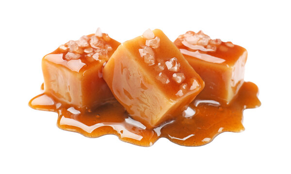 Tasty candies with salt and caramel sauce isolated on white