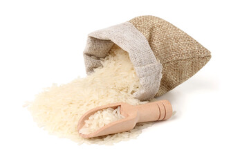 Rice is poured from a jute sack and scooped up with a wooden spoon. isolated on white background.