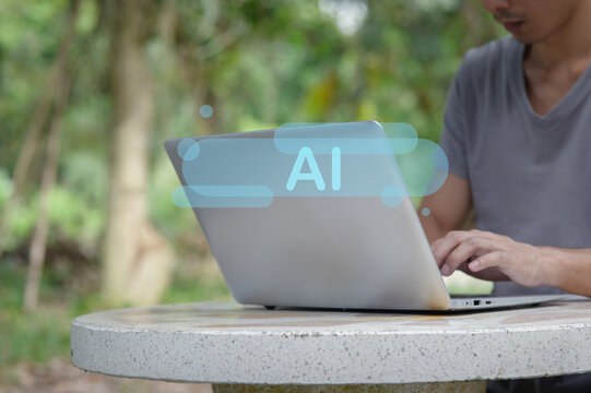 Man Using Laptop Outdoors with AI Concept Overlay in Nature Setting - Powered by Adobe