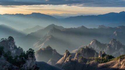 Golden sunrise over rocky mountain ridges